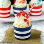 side view of a pina colada cupcakes with three more lined in the background