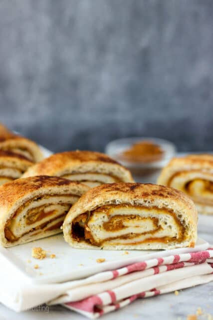 side view of slices of a pumpkin pie roll on a plate