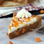 closeup of a slice of pumpkin cookie cake topped with frosting and pumpkin ganache