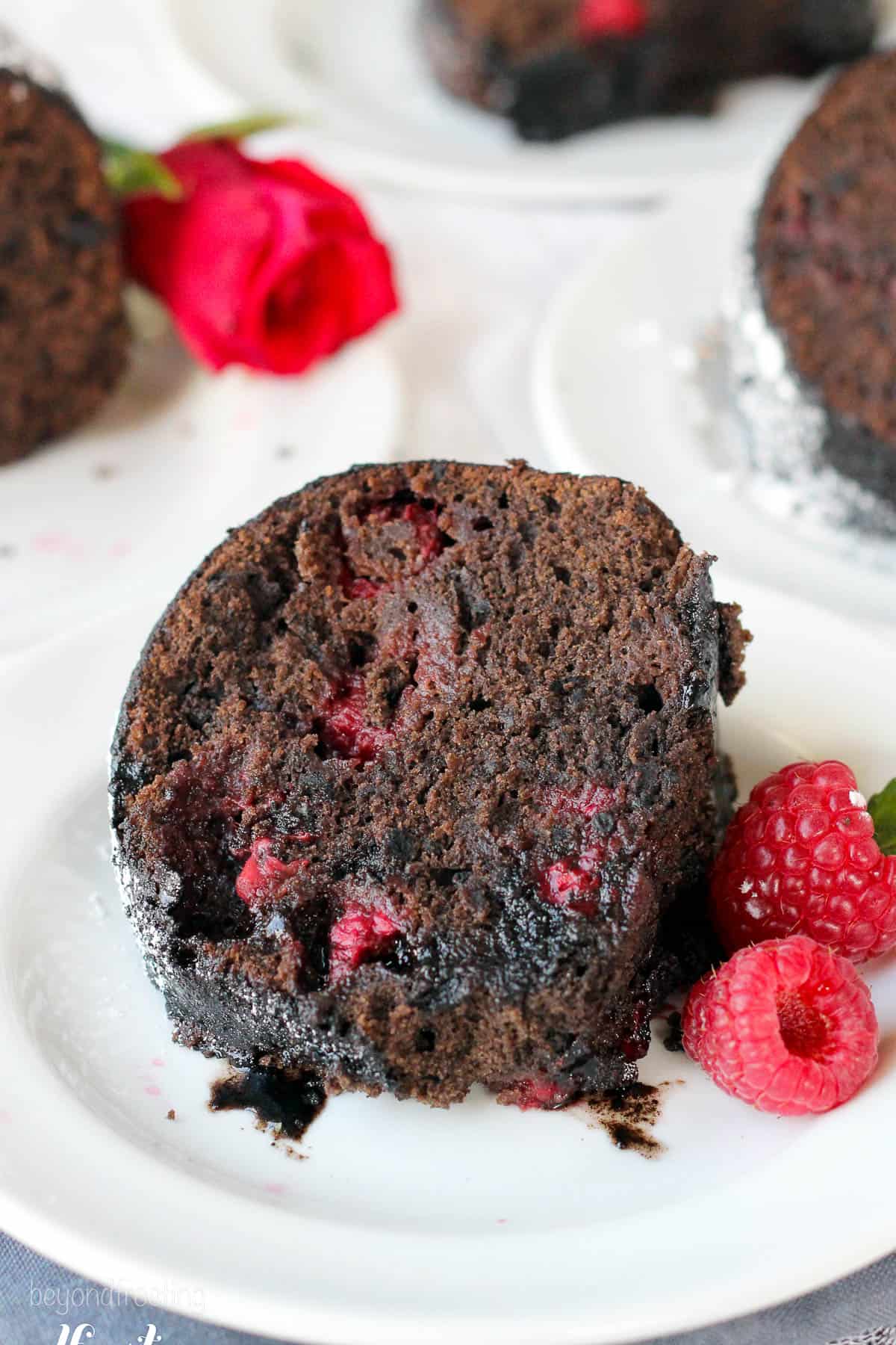 overhead of a slice of chocolate raspberry cake on a white plate