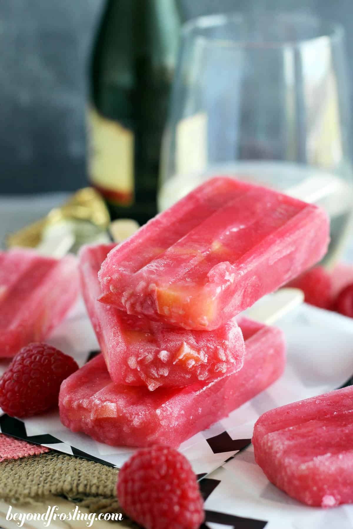 three raspberry peach popsicles stacked