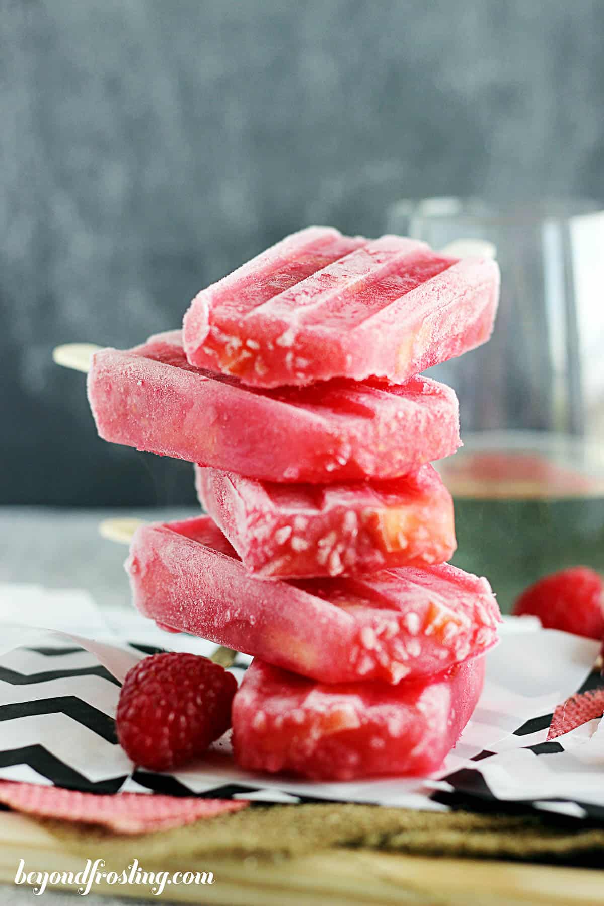 five peach raspberry popsicles stacked