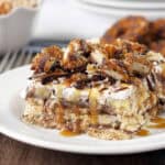 closeup of a slice of samoa icebox cake topped with cookies and caramel