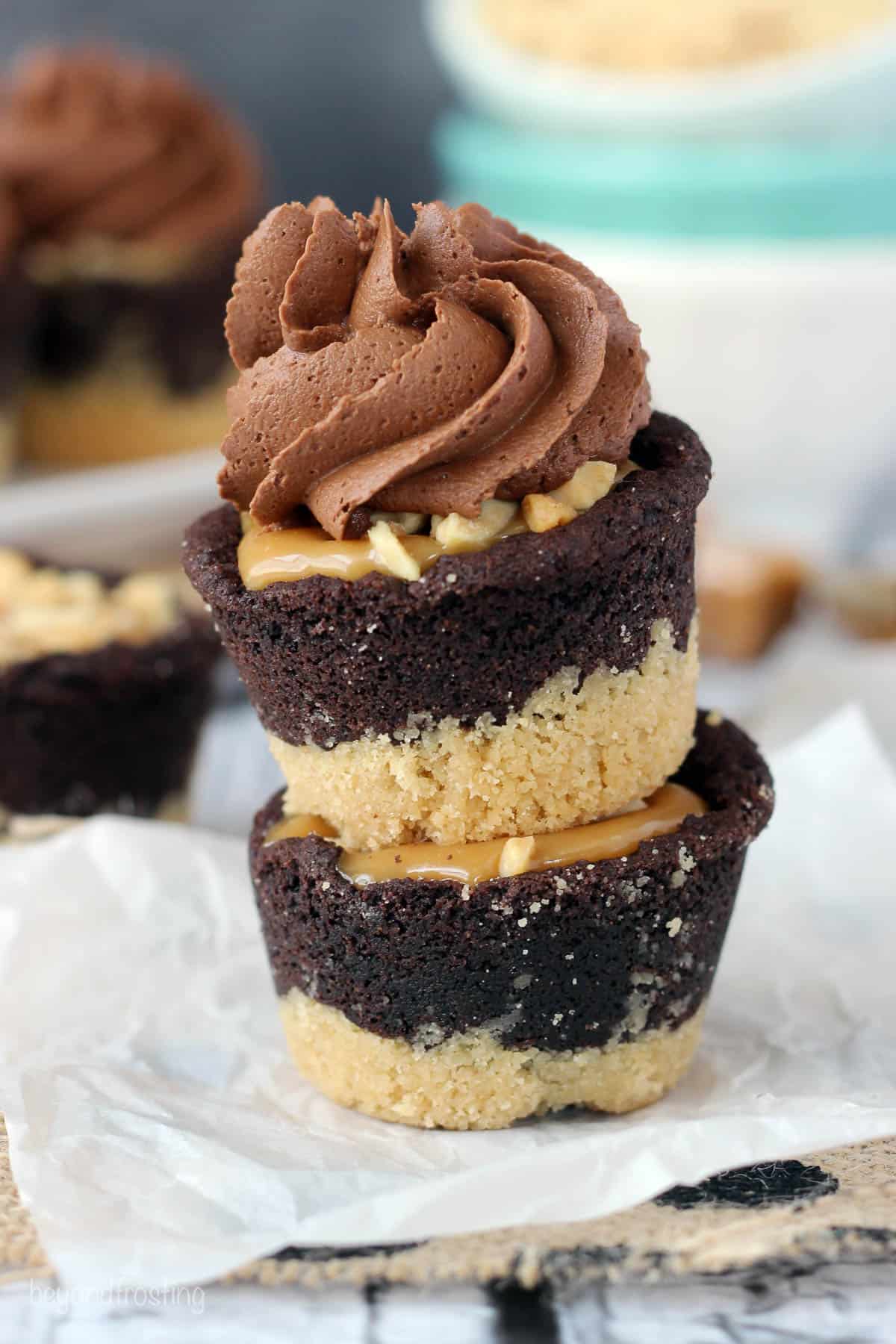 two cookie cups stacked with frosting on the top one