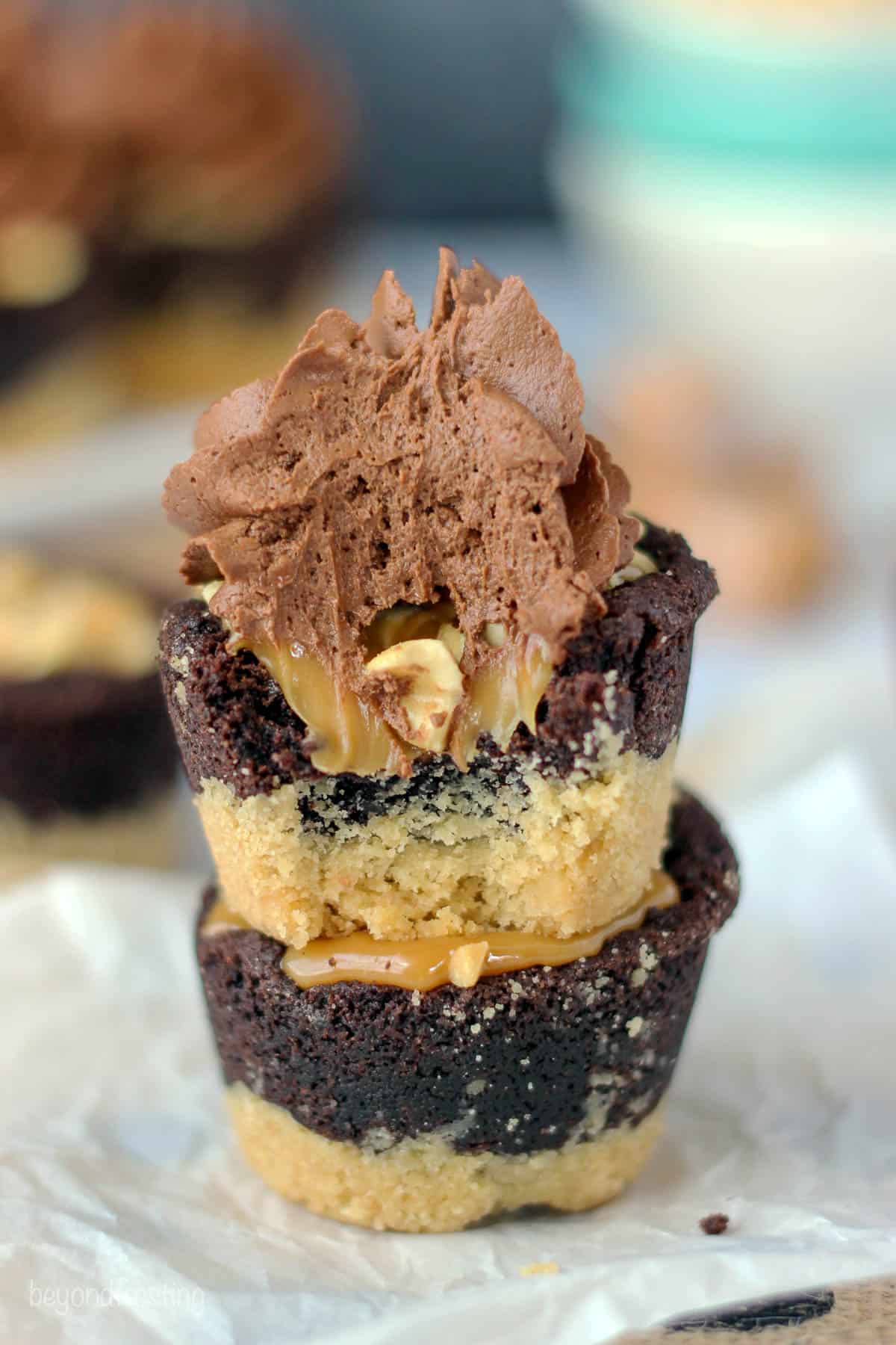 two snickers cookie cups stacked with a bite taken out of the top one