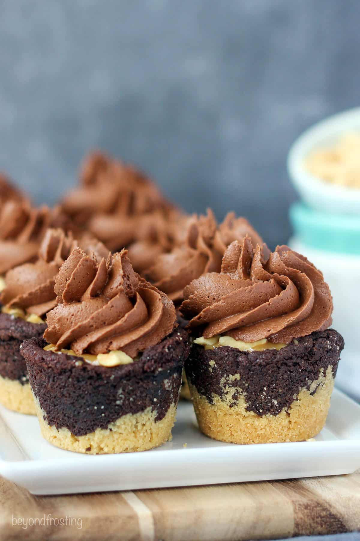 side view of cookie cups lined on a white plate