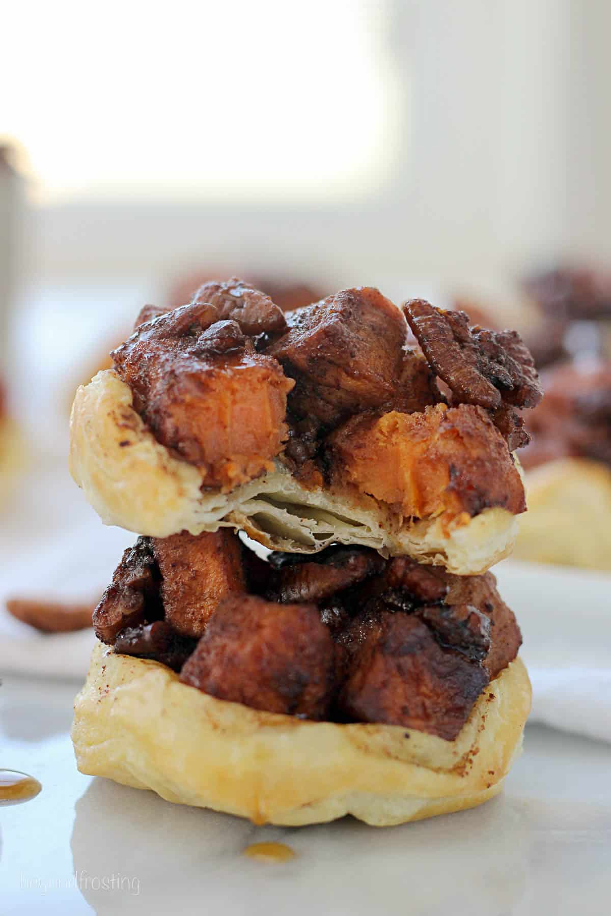 two sweet potato puffs stacked with a bite taken out of the top one