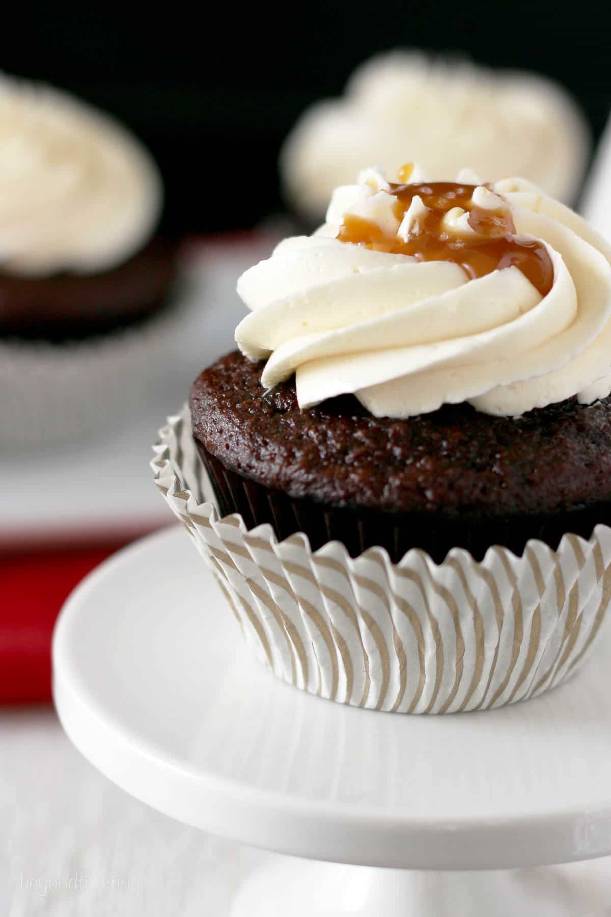 side view of a hot chocolate cupcake on a cupcake stand