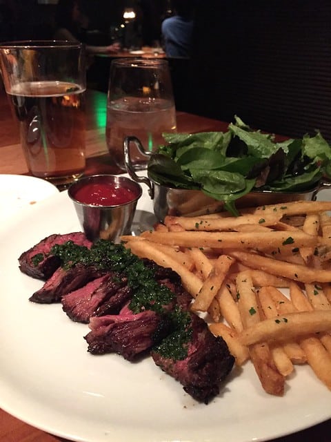 Steak frites on a plate at a restaurant