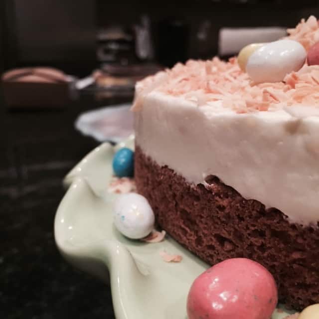 Close-up of a chocolate cake with pink frosting and easter egg candies