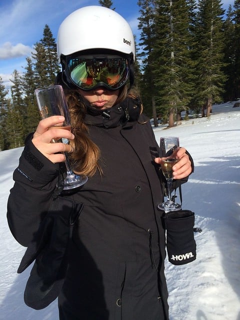 Author in snow gear holding a champagne glass