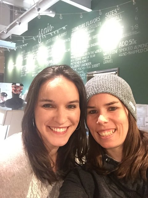 Selfie of blog author and her friend Lindsay with a menu board behind