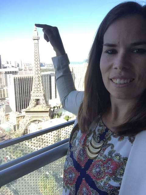 Author holding her hand over Eiffel Tower in the skyline in Vegas