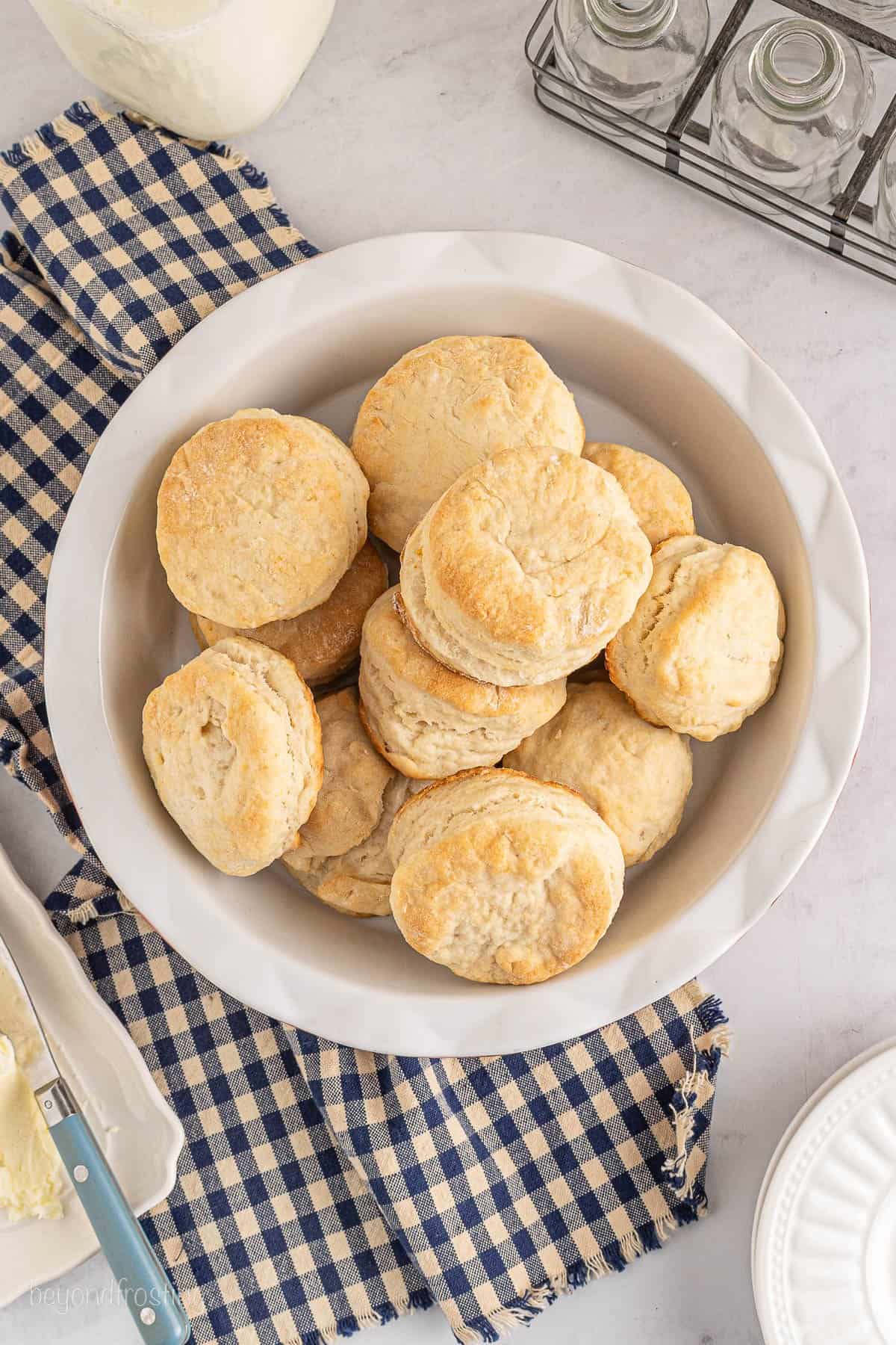 Overhead view of homemade biscuits in a white bowl