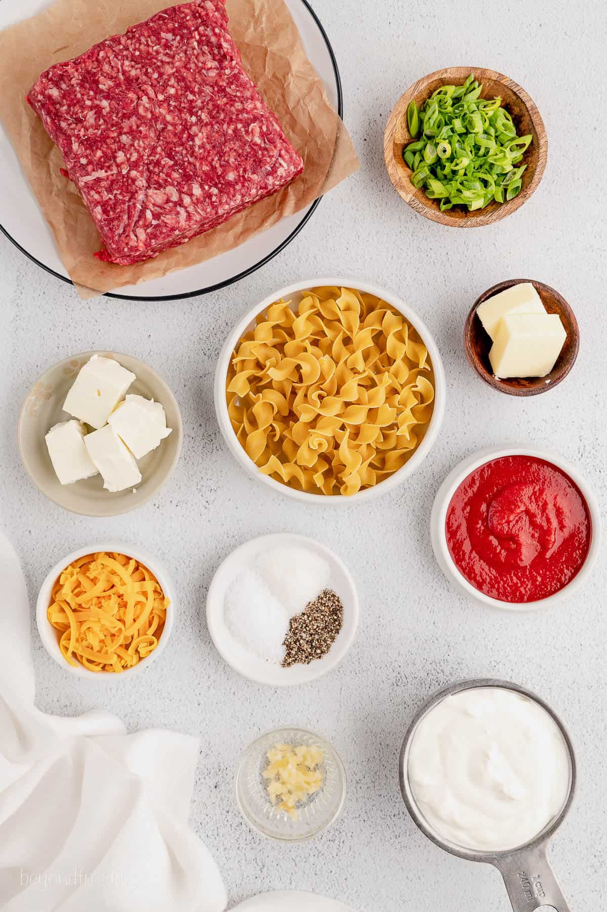 Overhead view of cheesy hamburger noodle casserole ingredients
