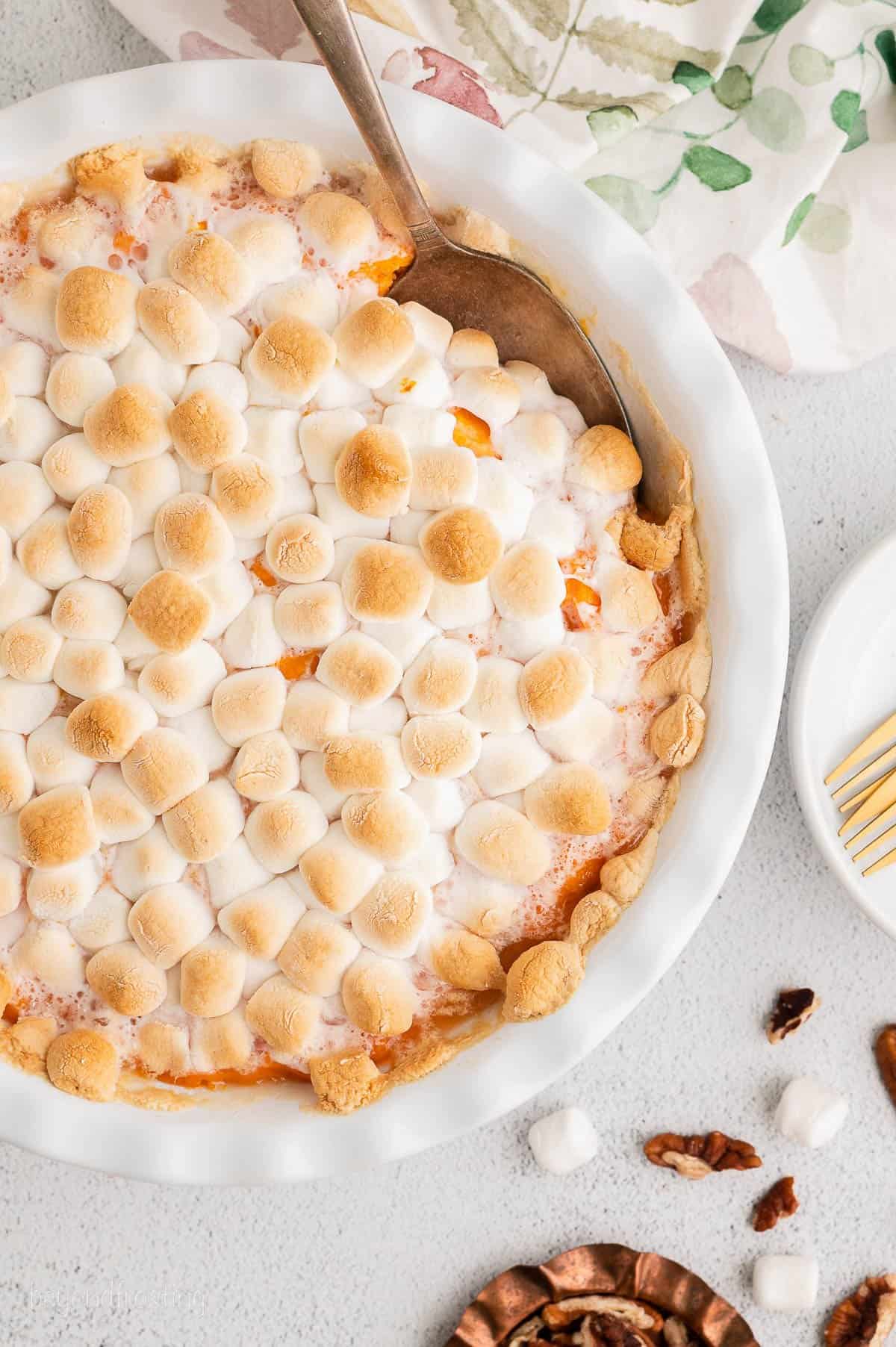 Baked sweet potato casserole with browned mini marshmallows on top.