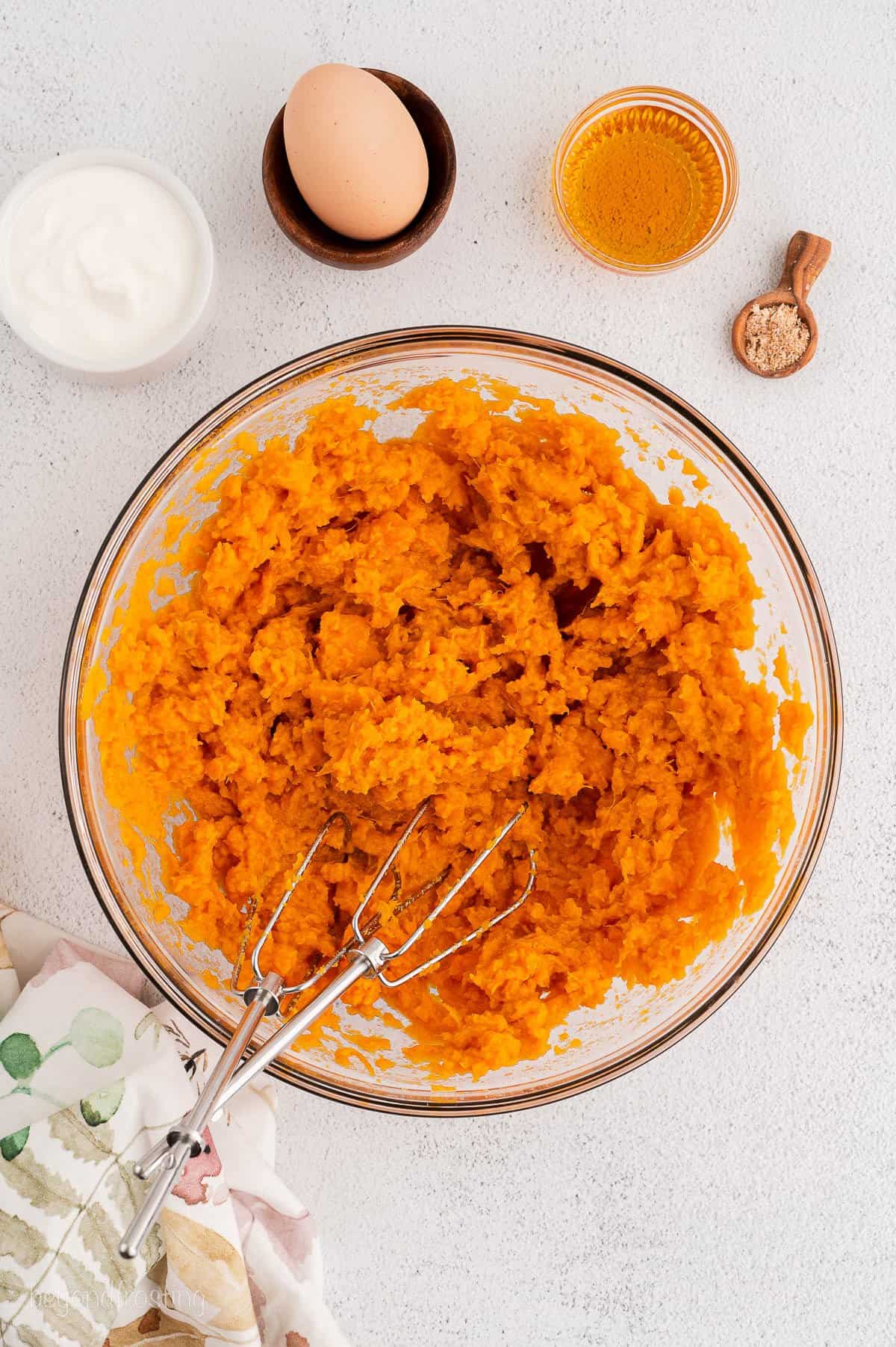 Cooked and mashed sweet potatoes in a bowl.
