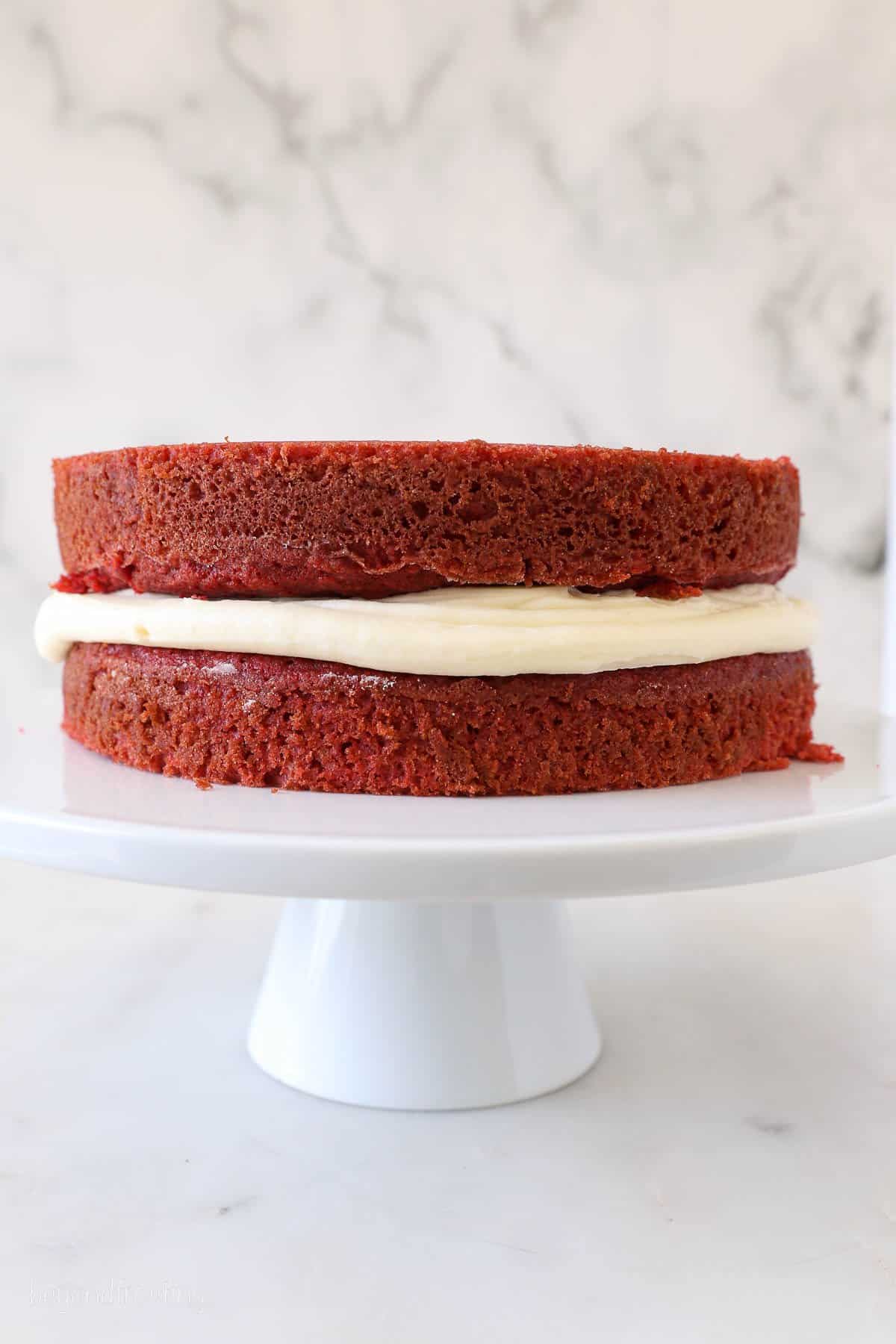 Two layers of red velvet cake with cream cheese frosting