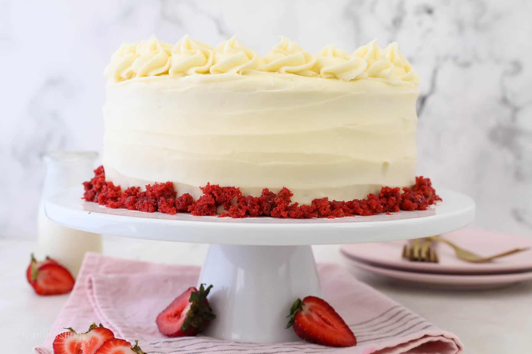 Gluten-free red velvet cake with cream cheese frosting on a cake stand