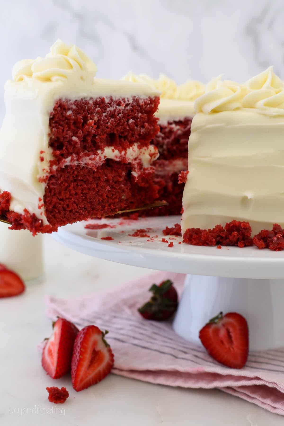 Angled view of red velvet cake with one slice missing