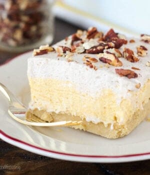 closeup of a slice of pumpkin lush topped with chopped pecans