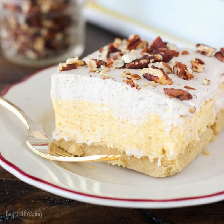closeup of a slice of pumpkin lush topped with chopped pecans