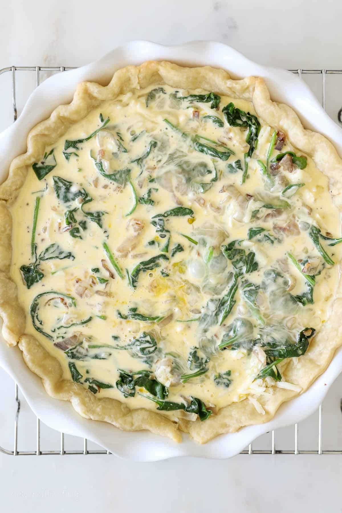 Overhead view of an unbaked quiche florentine