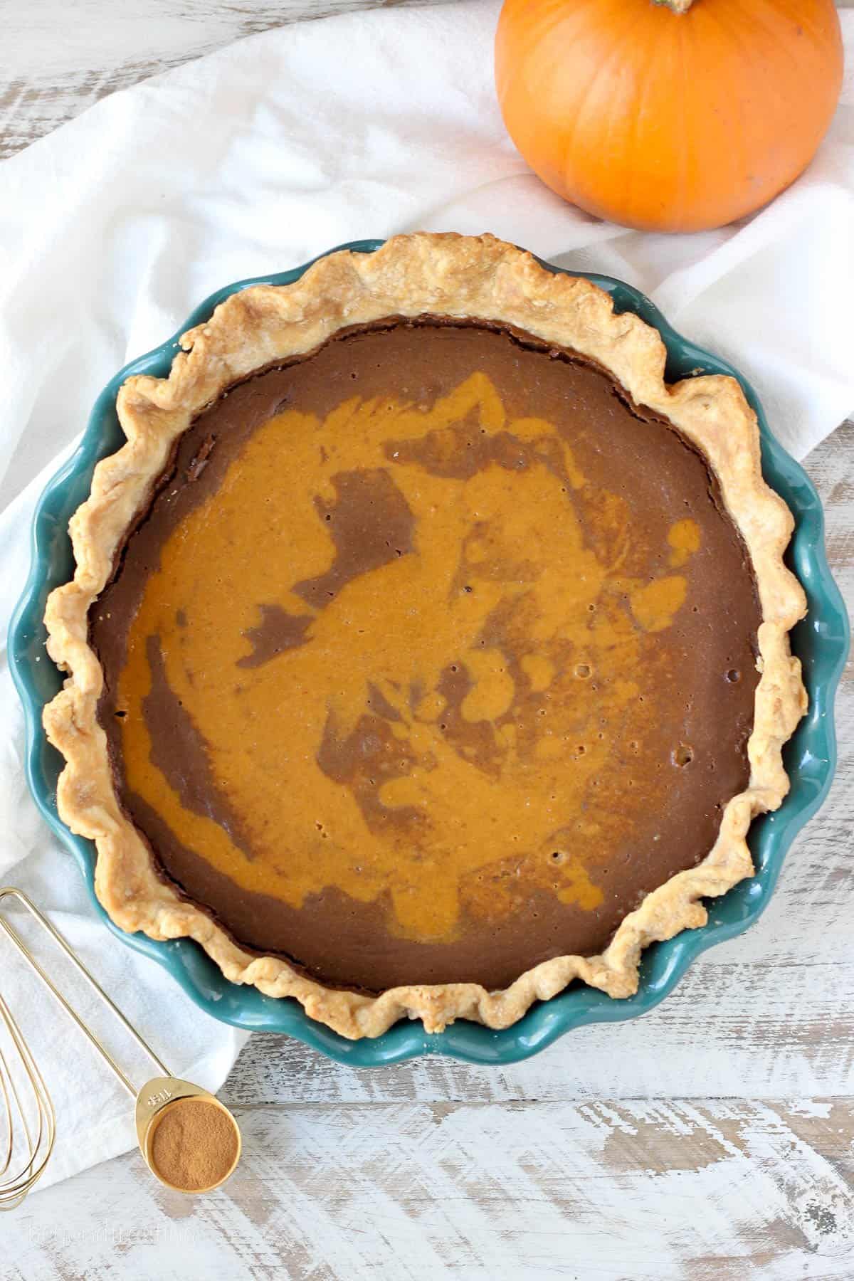 overhead of a marbled chocolate pumpkin pie in a pie dish