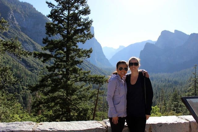 Two girlfriends posing in front of mountains at Yosemite