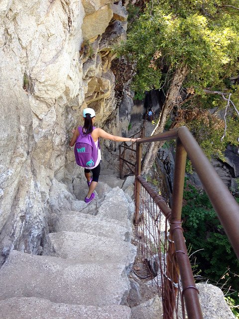 A person walking down rock stairs at Yosemite