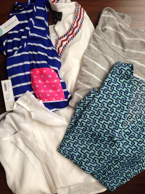 Overhead view of five folded shirts from a Stitch Fix order