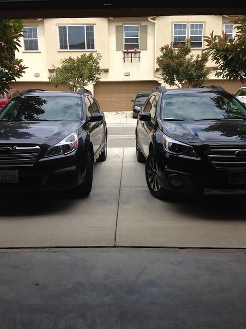 Front view of two Subaru Outbacks parked next to each other in the driveway