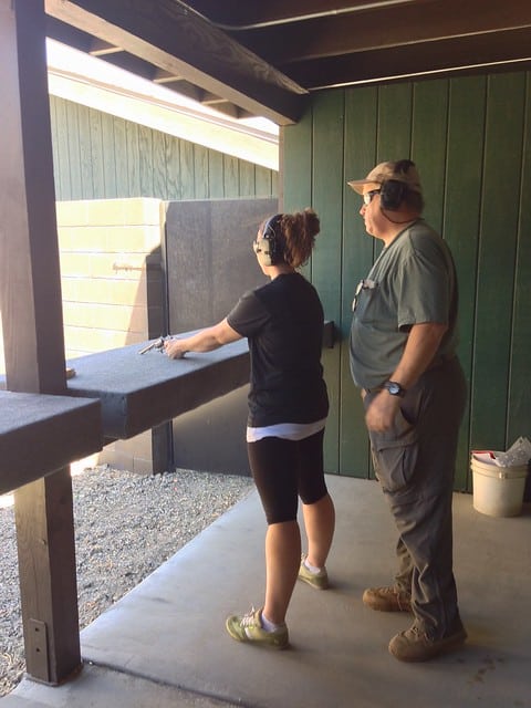 The author at a shooting range with an instructor