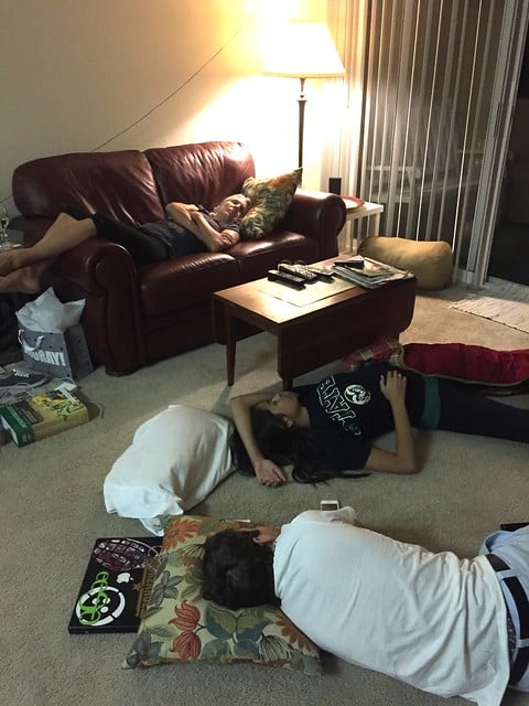 Everyone asleep on the couch and floor after a big meal