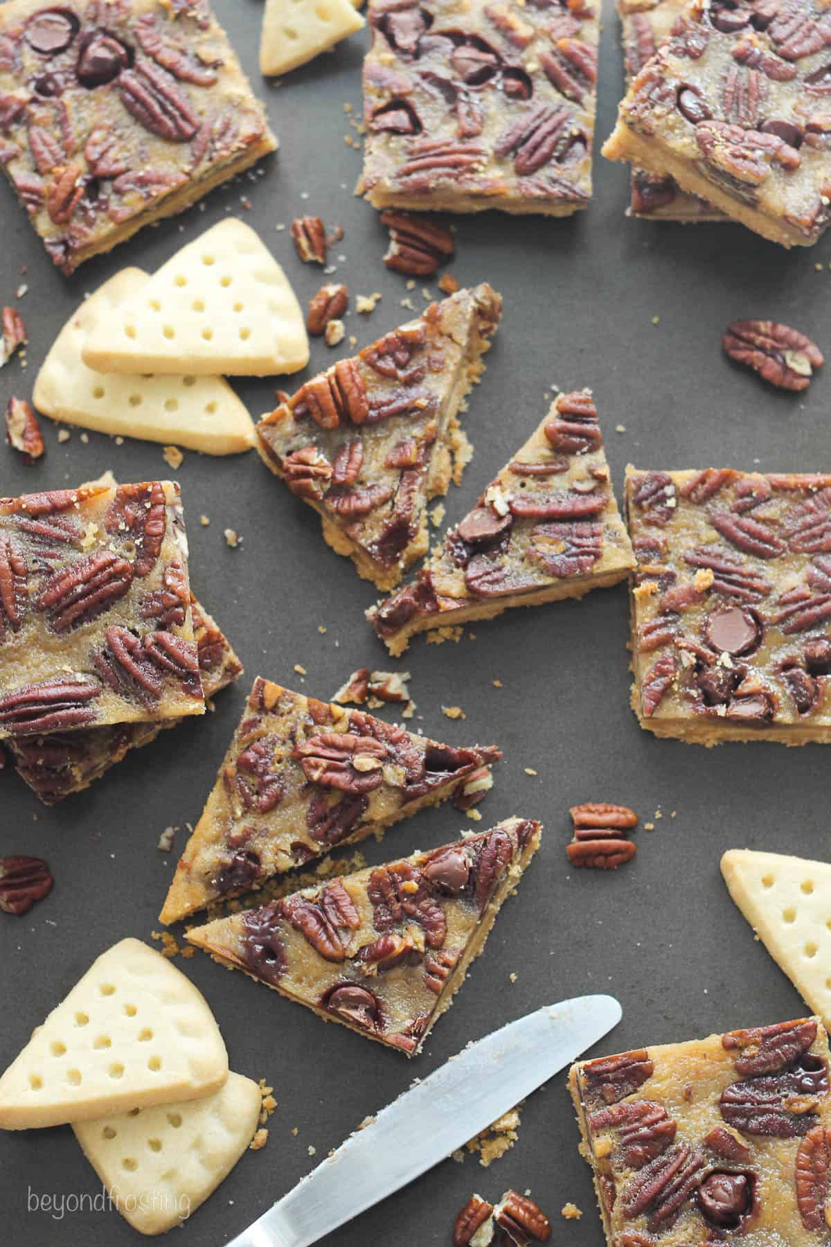overhead of pecan pie bars on a counter laid out with shortbread cookies