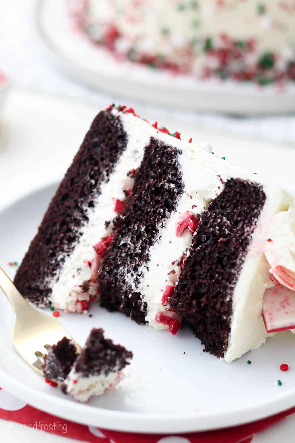 overhead of a slice of peppermint cake on a plate next to a fork