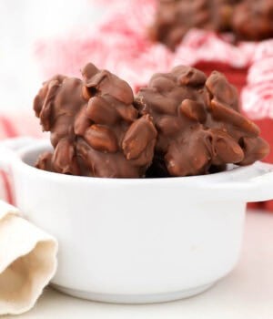 closeup of peanut clusters in a small white bowl