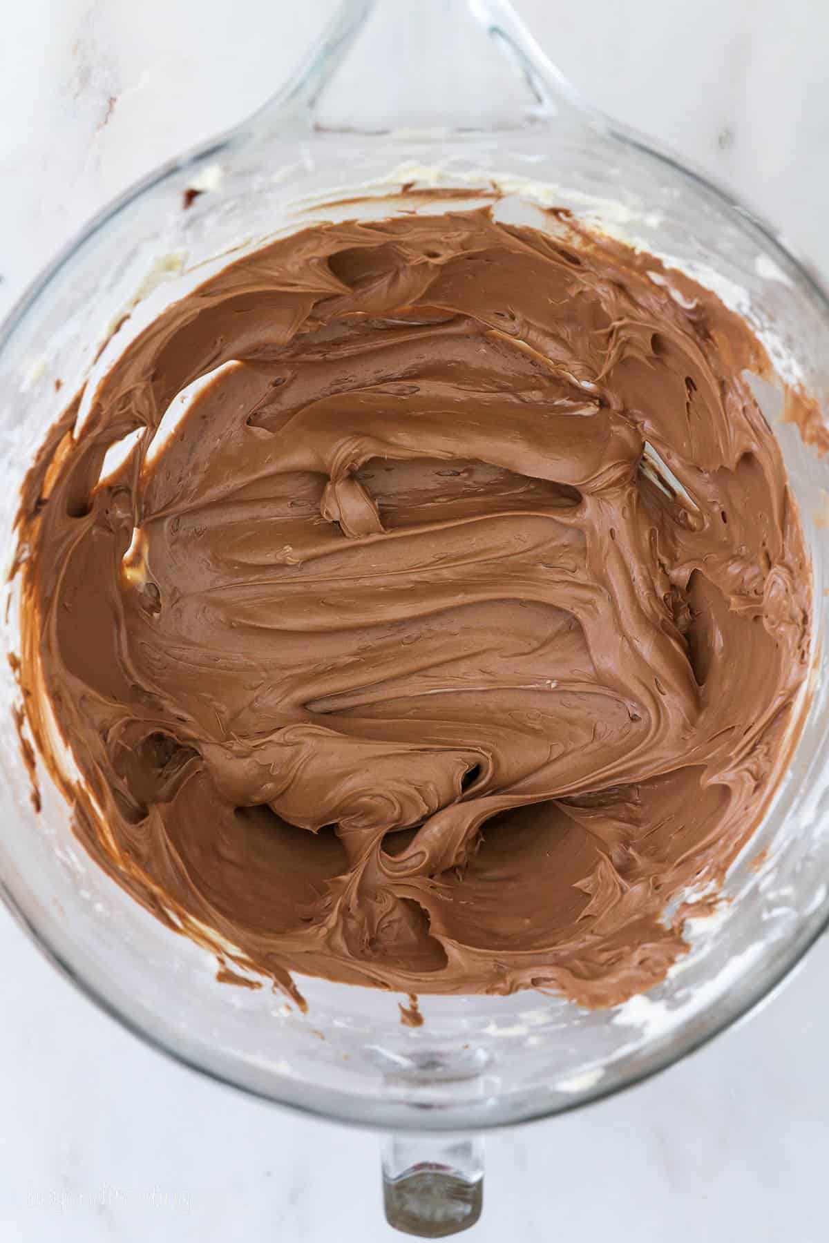 Nutella buttercream frosting in a glass bowl.