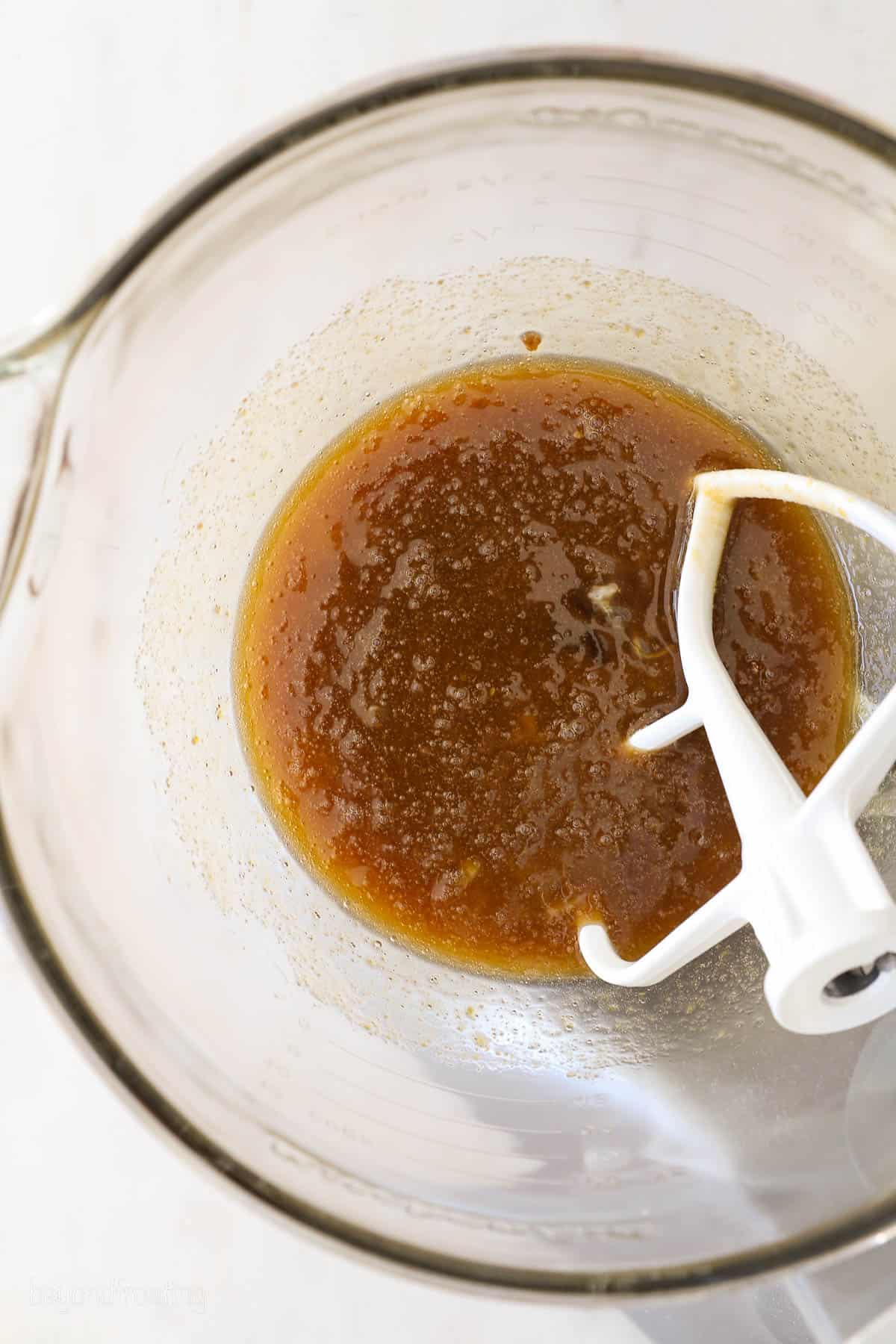 Process photo of pumpkin cupcake batter, brown sugar mixed with wet ingredients