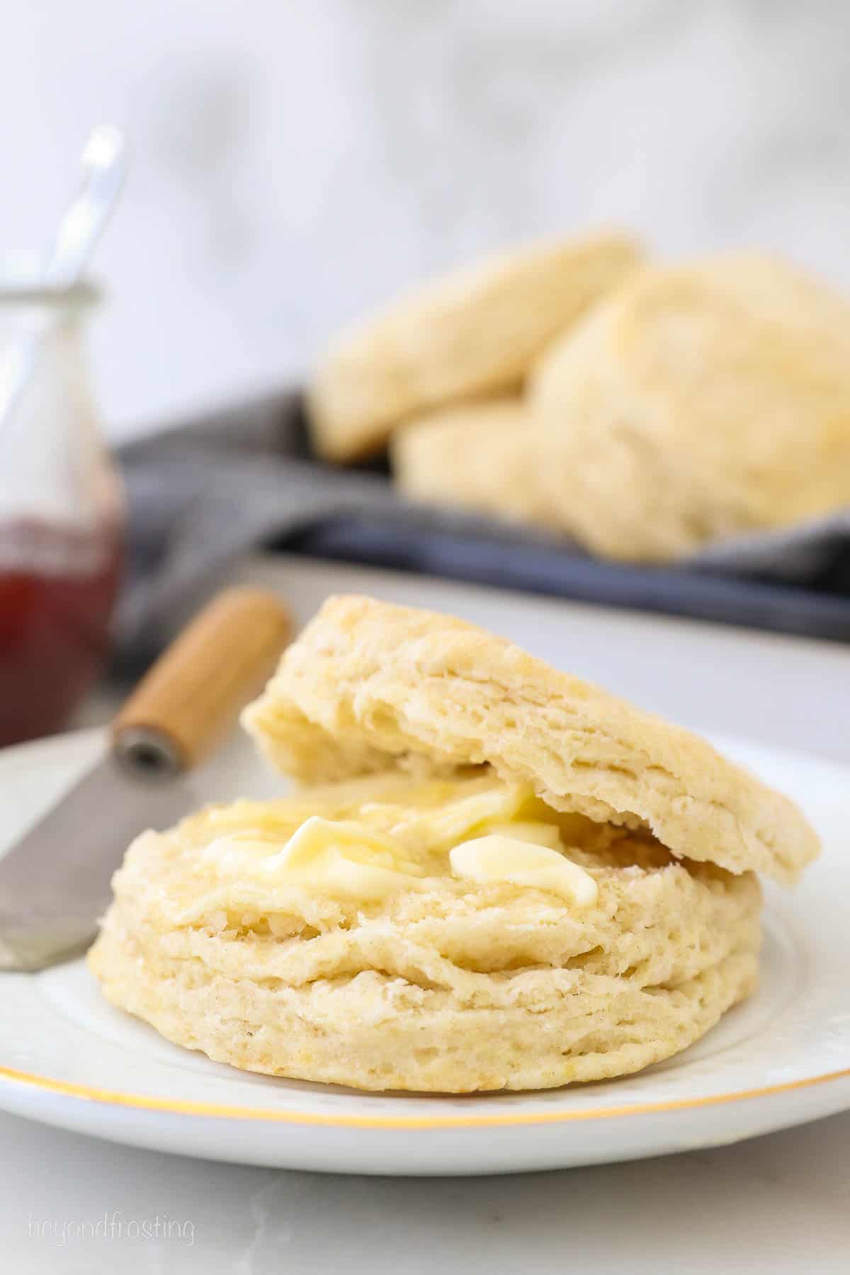 A biscuit cut in half with melted butter