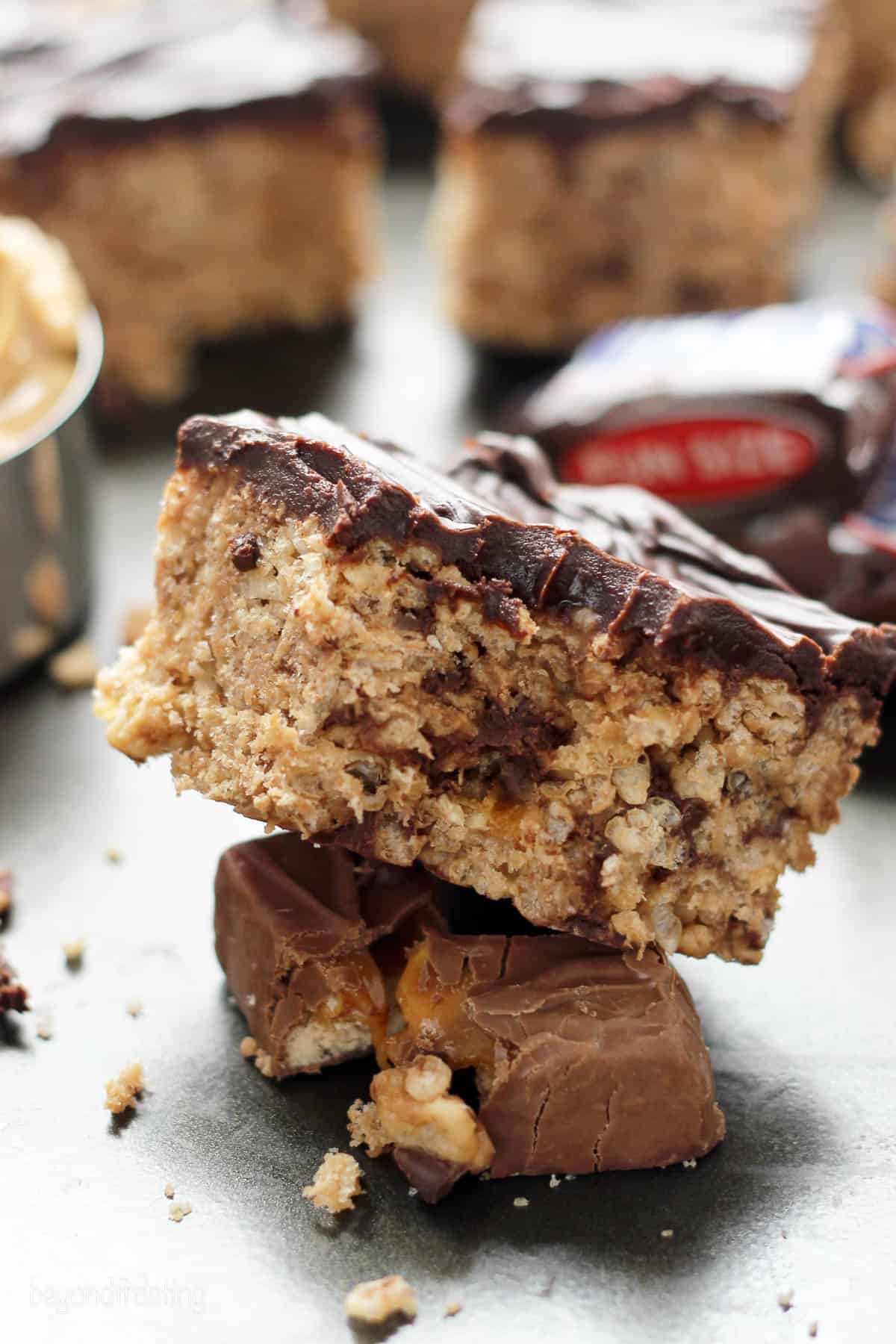 a rice krispie treat stacked on top of a snickers bar