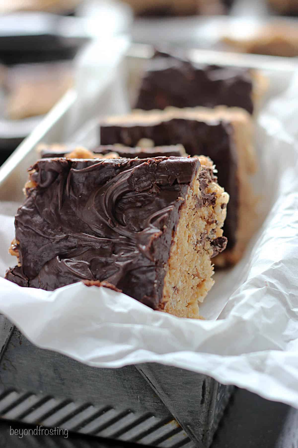 a parchment-lined baking dish lined with rice krispie treats