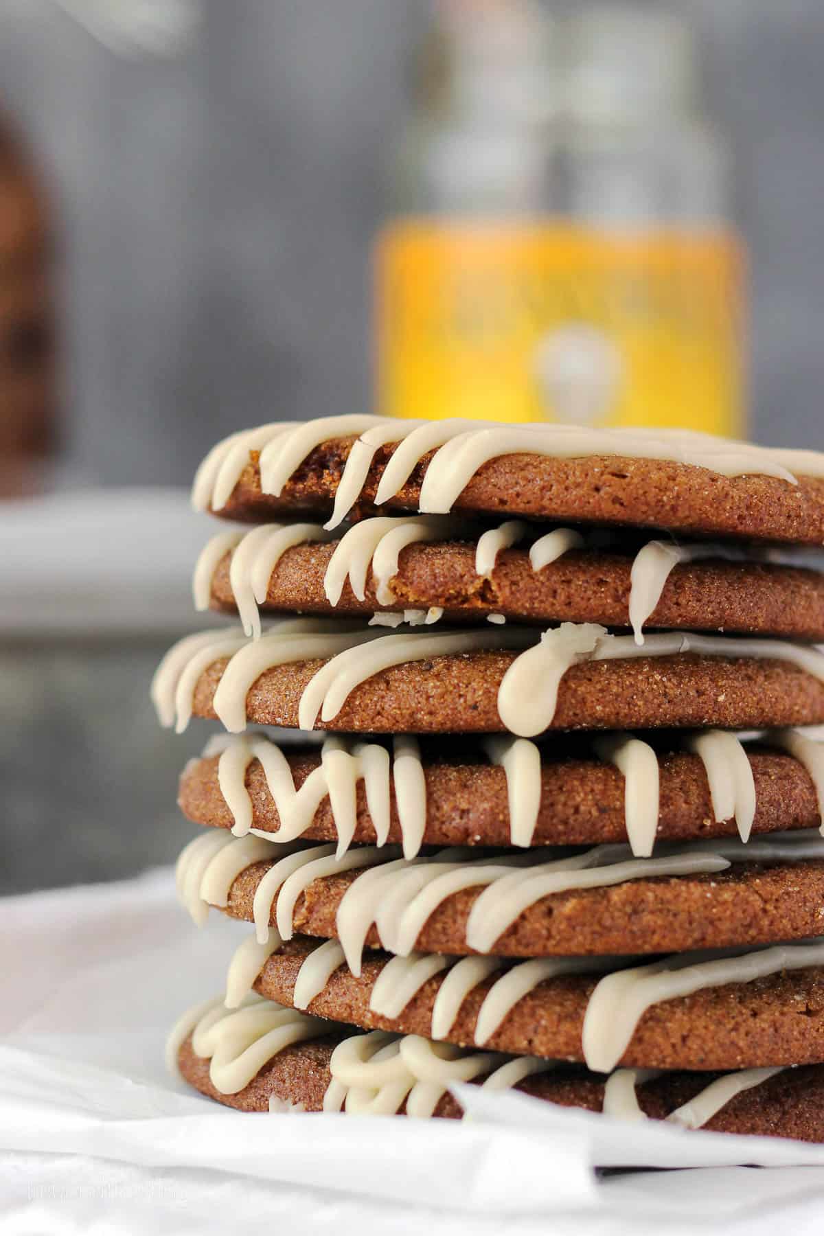 seven molasses cookies with maple glaze stacked