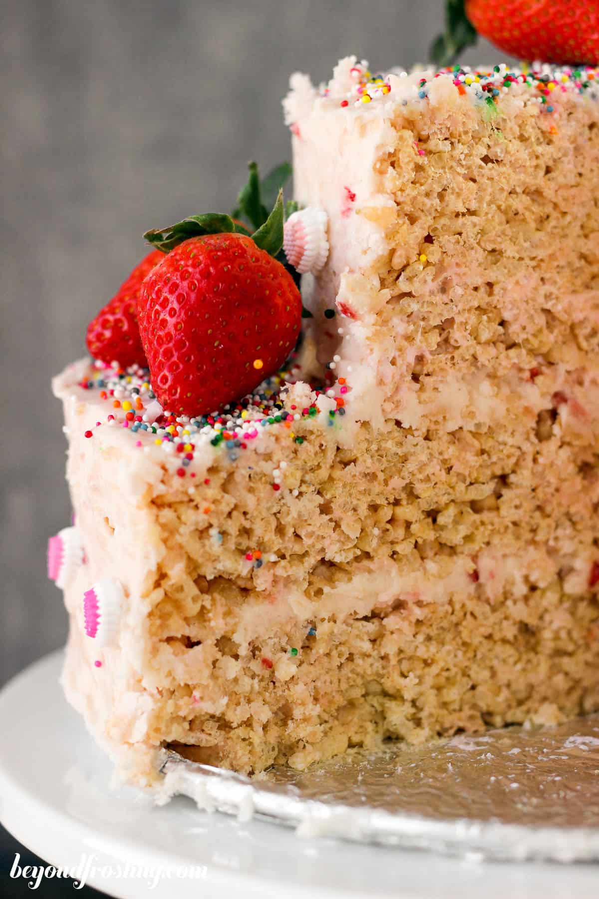a closeup of the inside of a rice krispie treat cake garnished with strawbwerries