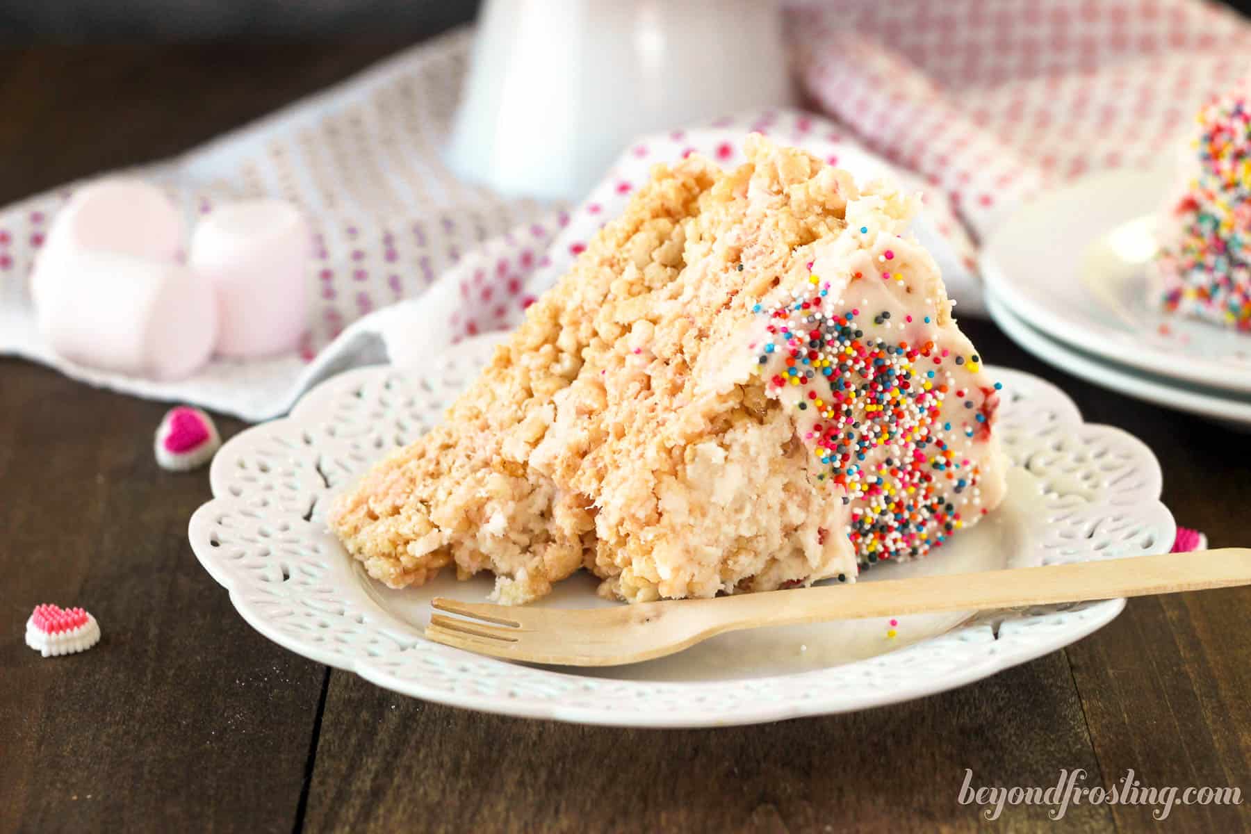 a slice of strawberry rice krispie treat cake on a white plate
