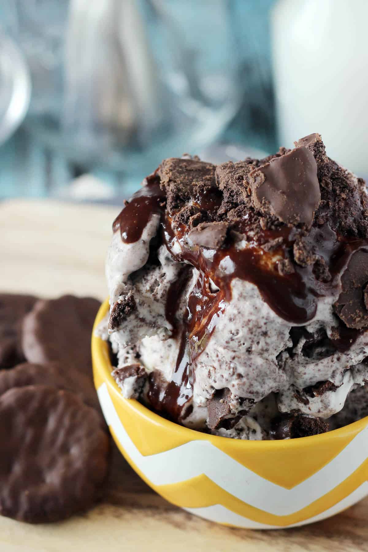 overhead of a bowl piled with ice cream topped with chocolate