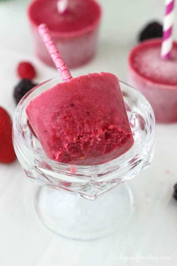 overhead of a berry popsicle in a glass bowl