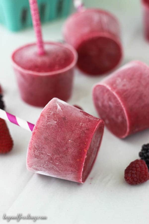 berry popsicles laying on a counter
