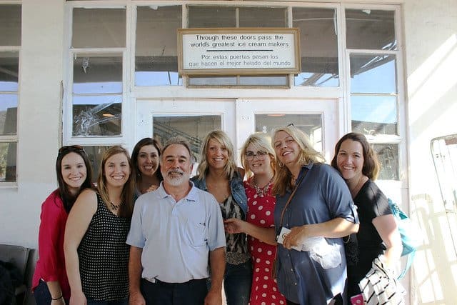 A group of food bloggers posing outside the entrance to the McConnell Ice Cream factory