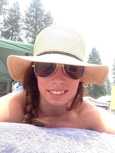 Blog author sunbathing with a hat and sunglasses on